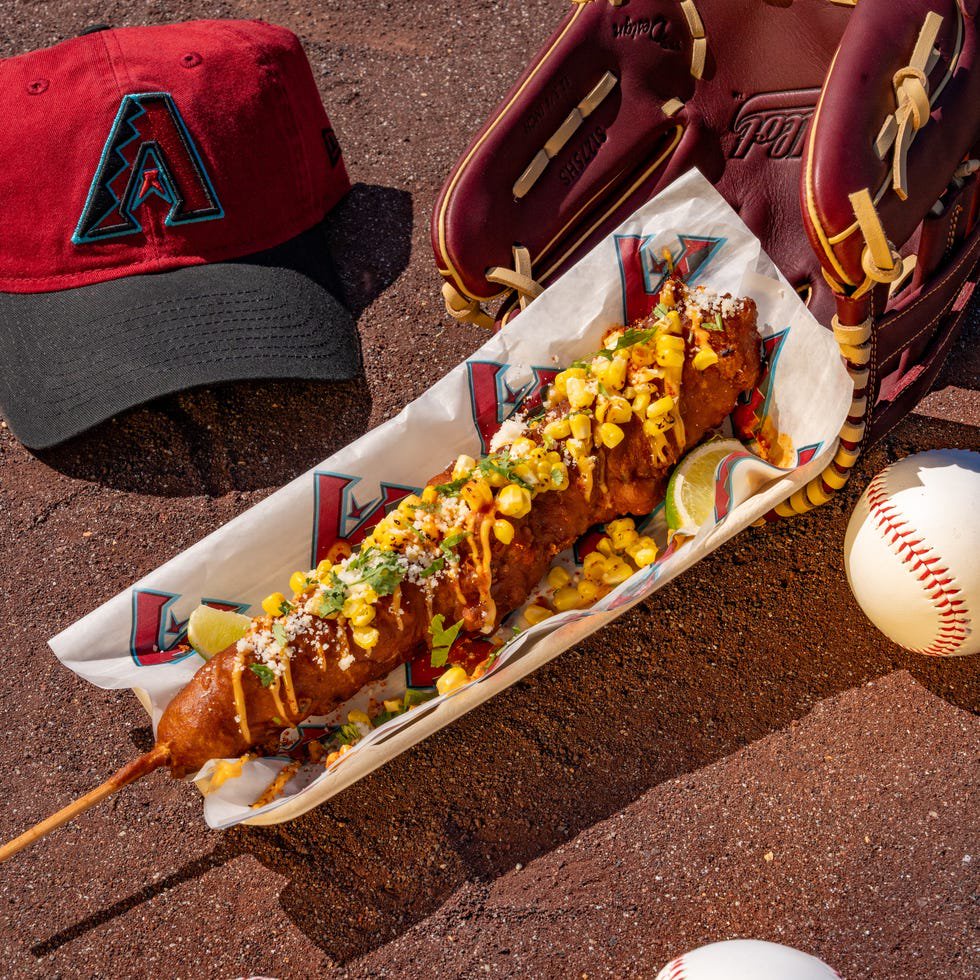 Baseball-themed snack setup with a cap, glove, and baseballs.