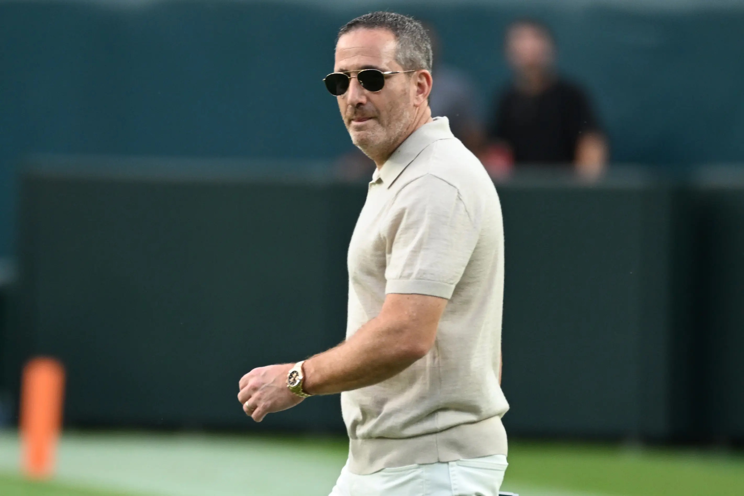 Howie Roseman wearing sunglasses on the field.