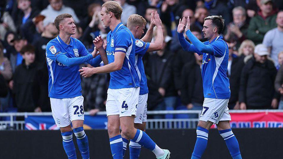 Birmingham City players celebrate after a goal against QPR
