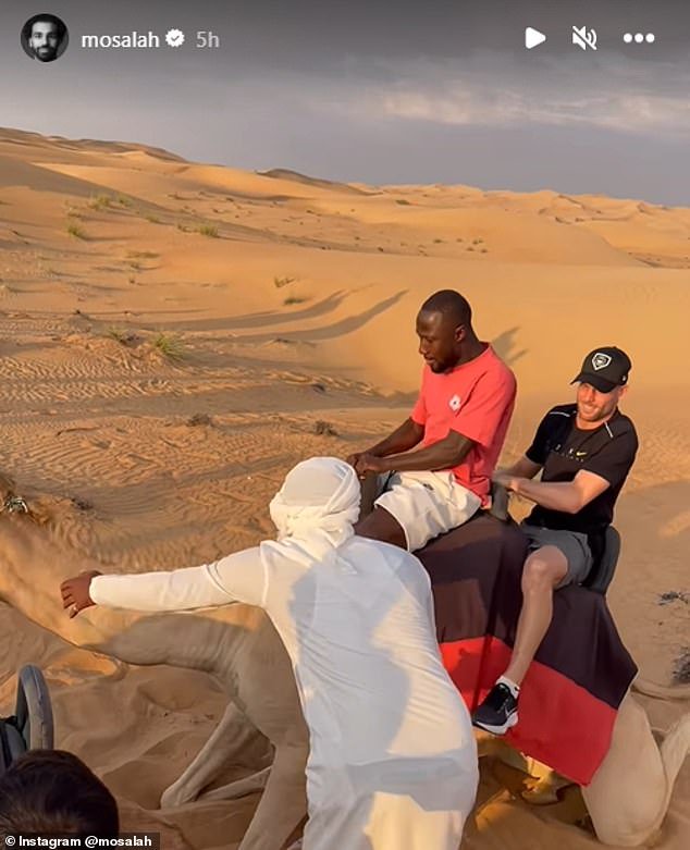 James Milner (right) and Naby Keita laughed as they rode a camel in the hot Dubai desert