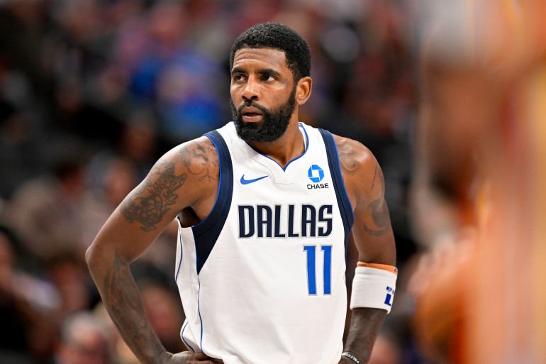 Dallas Mavericks guard Kyrie Irving (11) looks on.