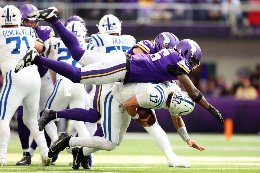 Minnesota's Dallas Turner and Harrison Smith sack Indianapolis' Daniel Jones on Sunday.