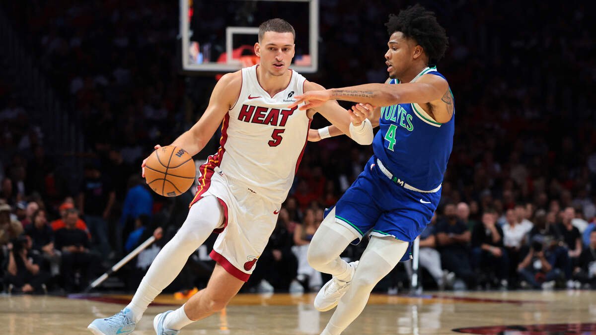 Miami Heat forward Nikola Jovic (5) drives to the basket against Minnesota Timberwolves guard Terrence Shannon Jr. (4) during the third quarter at Kaseya Center.