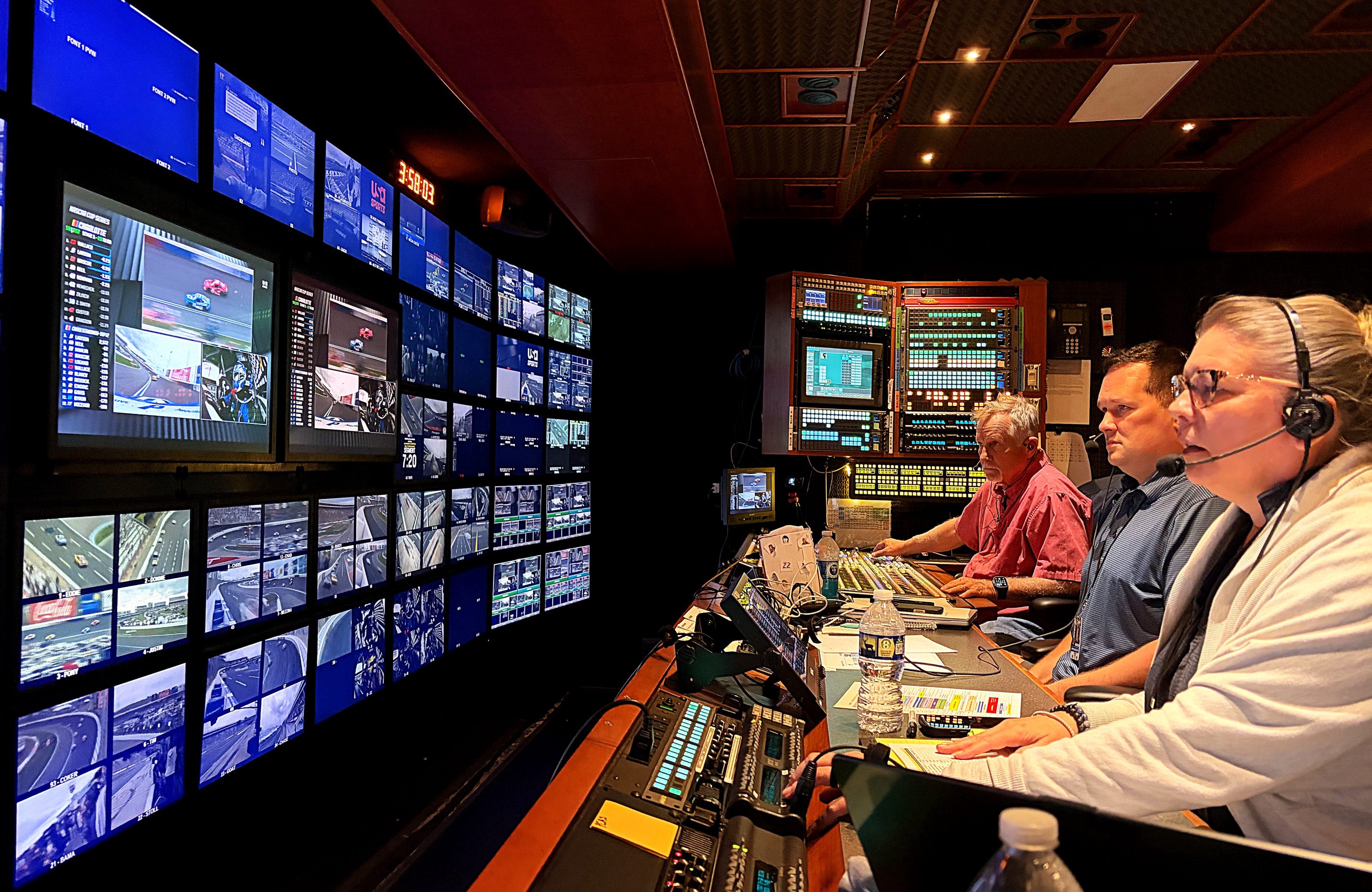 Rene Hatlelid, Sean Owens and Derrell Harman sit inside the main production trailer for USA Sports during the Bank of America 400 at Charlotte Motor Speedway on Sunday, Oct. 11, 2026.