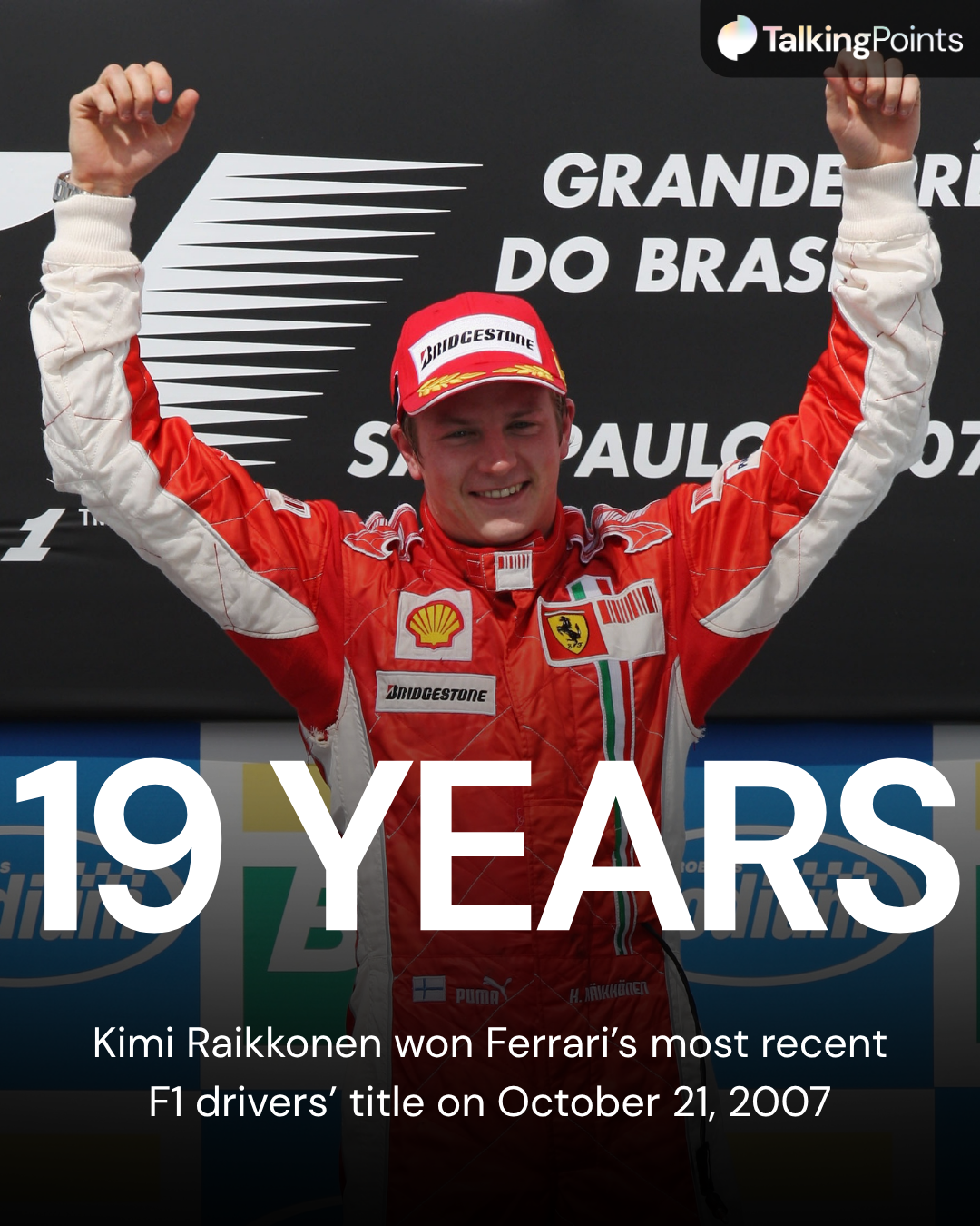 Kimi Raikkonen celebrates winning the 2007 F1 driver's title for Ferrari on the Brazilian Grand Prix podium