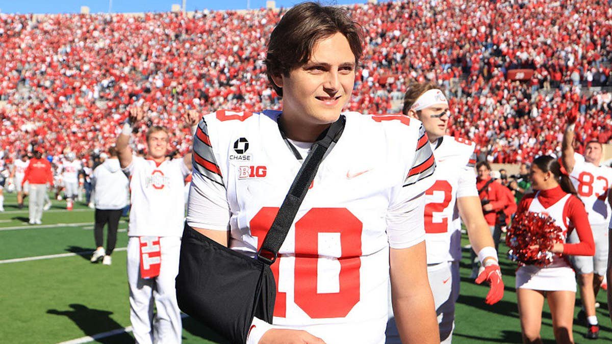 Julian Sayin walks off the field with his arm in a sling.