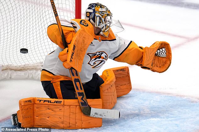 A shot by Pittsburgh Penguins' Ville Koivunen gets behind Nashville Predators goaltender Juuse Saros for the winning goal in overtime of an NHL hockey game in Pittsburgh, Saturday, Oct. 24, 2026. (AP Photo/Gene J. Puskar)