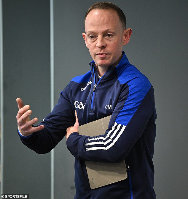 Referee Chris Mooney briefs both sets of players and managers