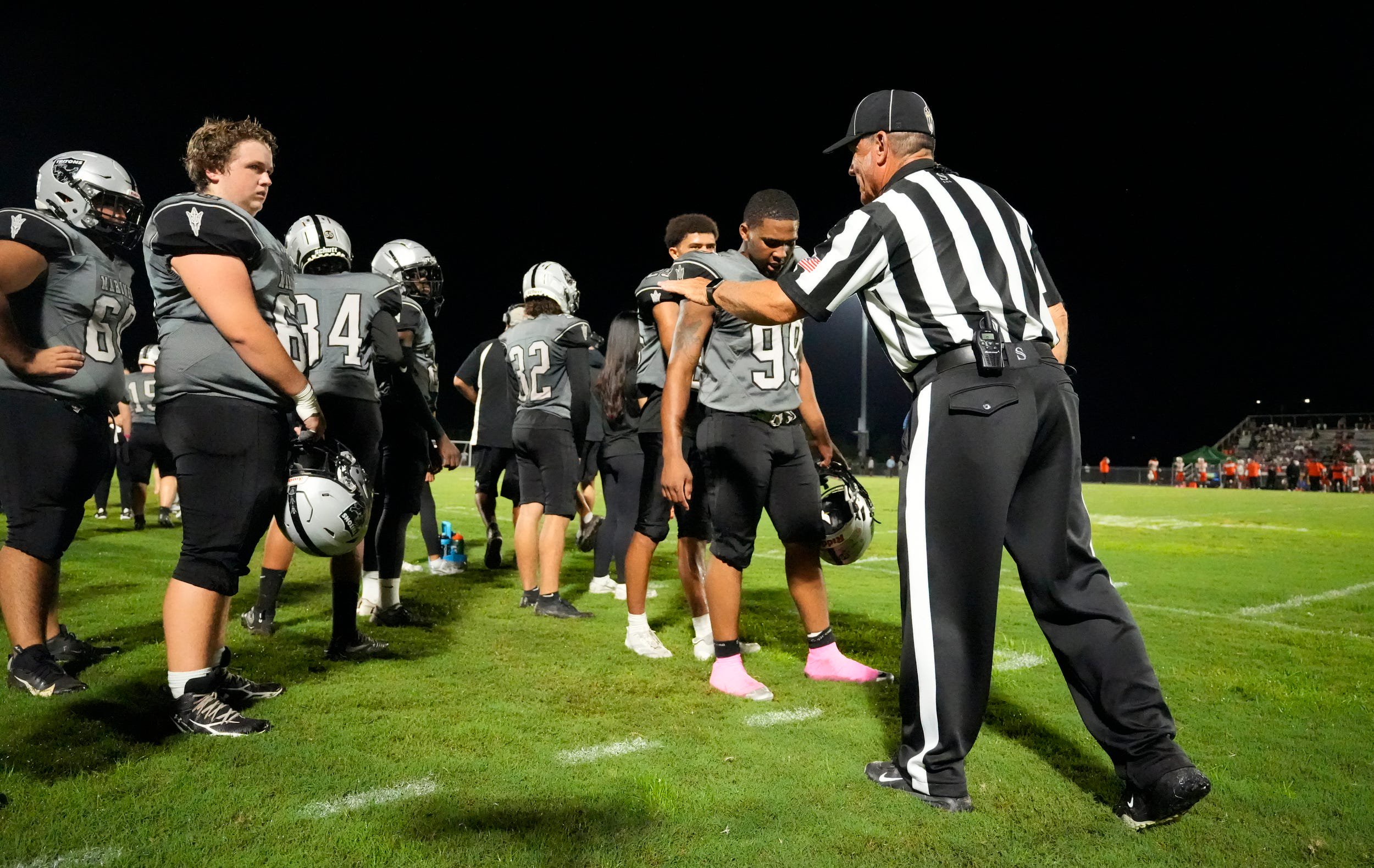 Sideline referee Ben Pfaff throws his penalty flag at the Mariner bench to warn them about excessive celebration after a touchdown. The Dunbar High School Tigers visited the Mariner High School Tritons Thursday, Oct. 8, 2026 for a 4A District 11 football matchup. 
Dunbar walked away with the victory with a final score of 60-20.