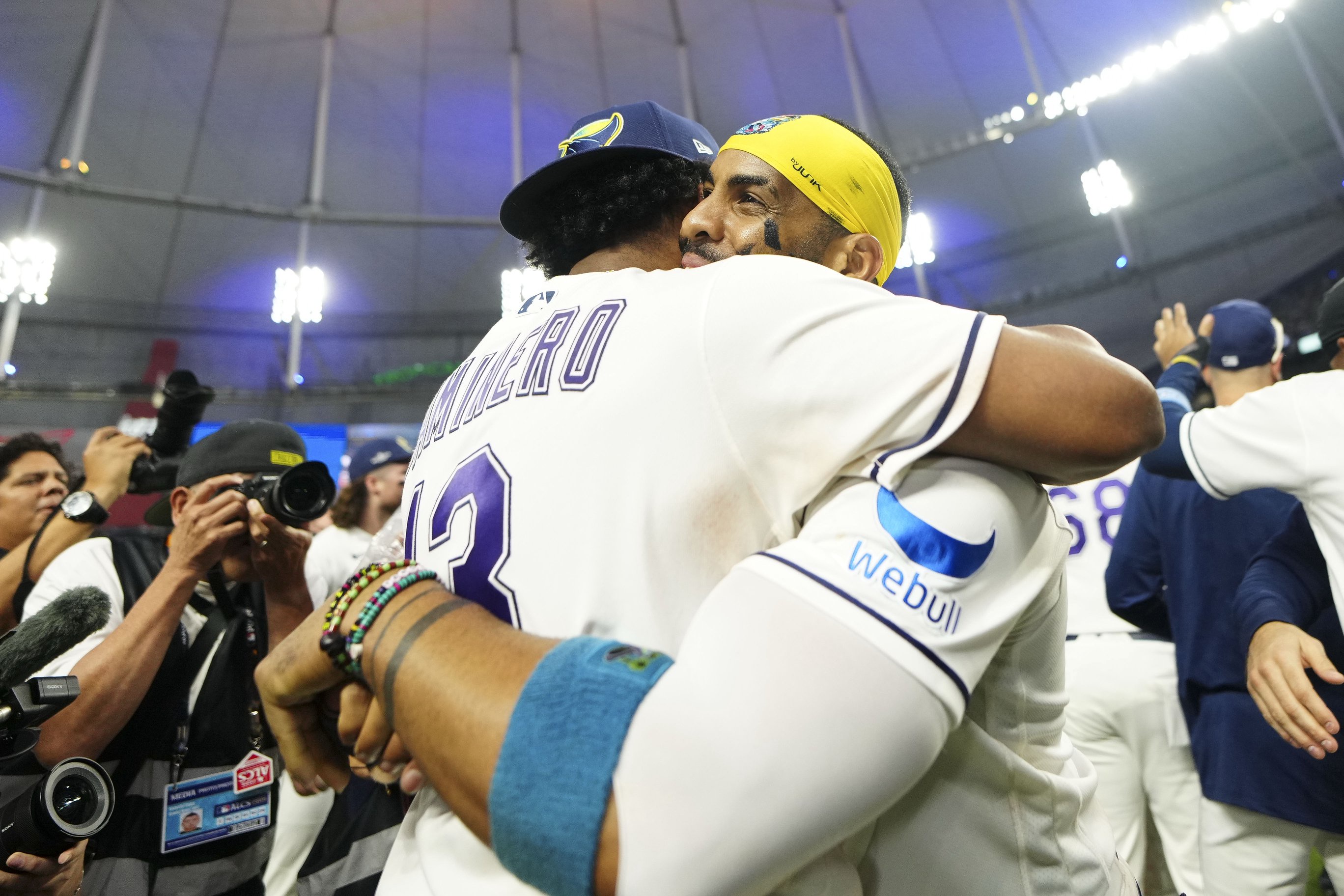 Yandy Díaz hugs Junior Caminero following Tampa Bay's ALCS-clinching victory over the Cleveland Guardians.