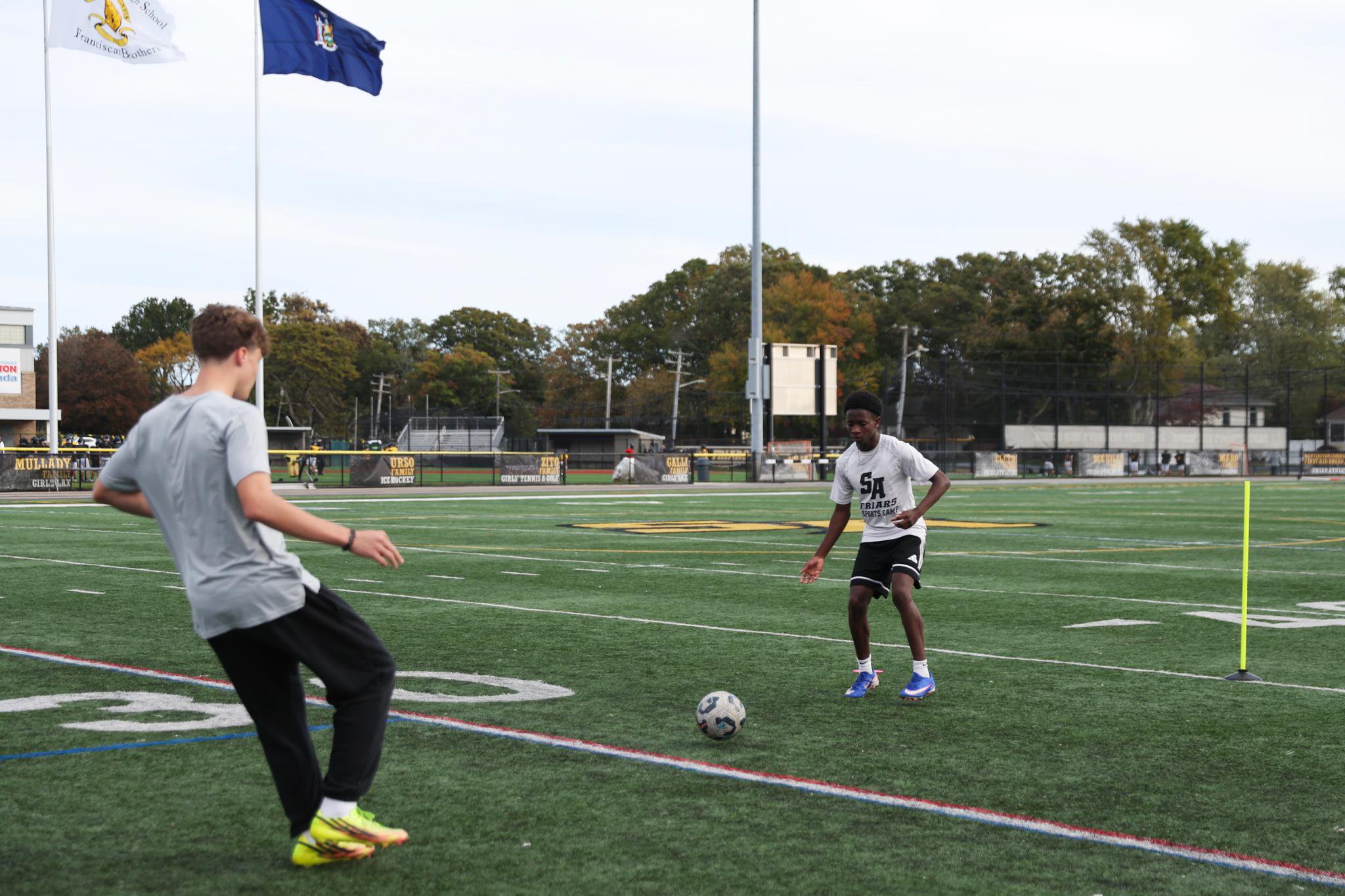 St. Anthony's boys soccer players run drills during practice.