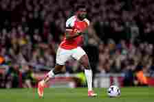 Thomas Partey of Arsenal runs with the ball during the Premier League match between Arsenal FC and Chelsea FC at Emirates Stadium on April 23, 2024...
