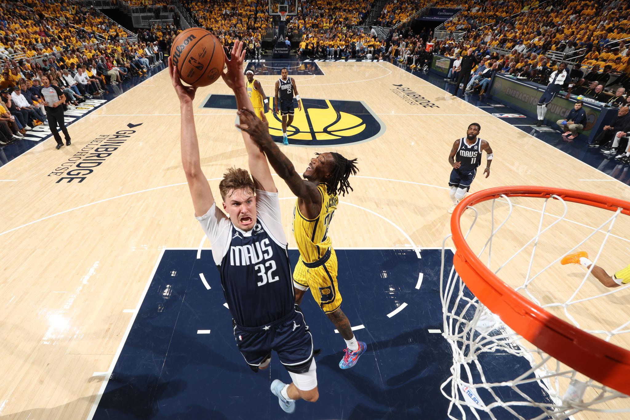 Cooper Flagg (32) is fouled on a drive by Pacers swingman Aarom Nesmith. 