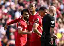 Mohamed Salah of Liverpool celebrates scoring his team's first goal with teammate Virgil van Dijk during the Premier League match between Liverpool...
