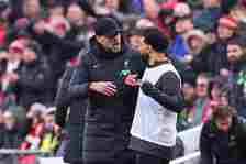 Jurgen Klopp, Manager of Liverpool (L) speaks with player Mohamed Salah on the touchline during the Premier League match between Liverpool FC and M...