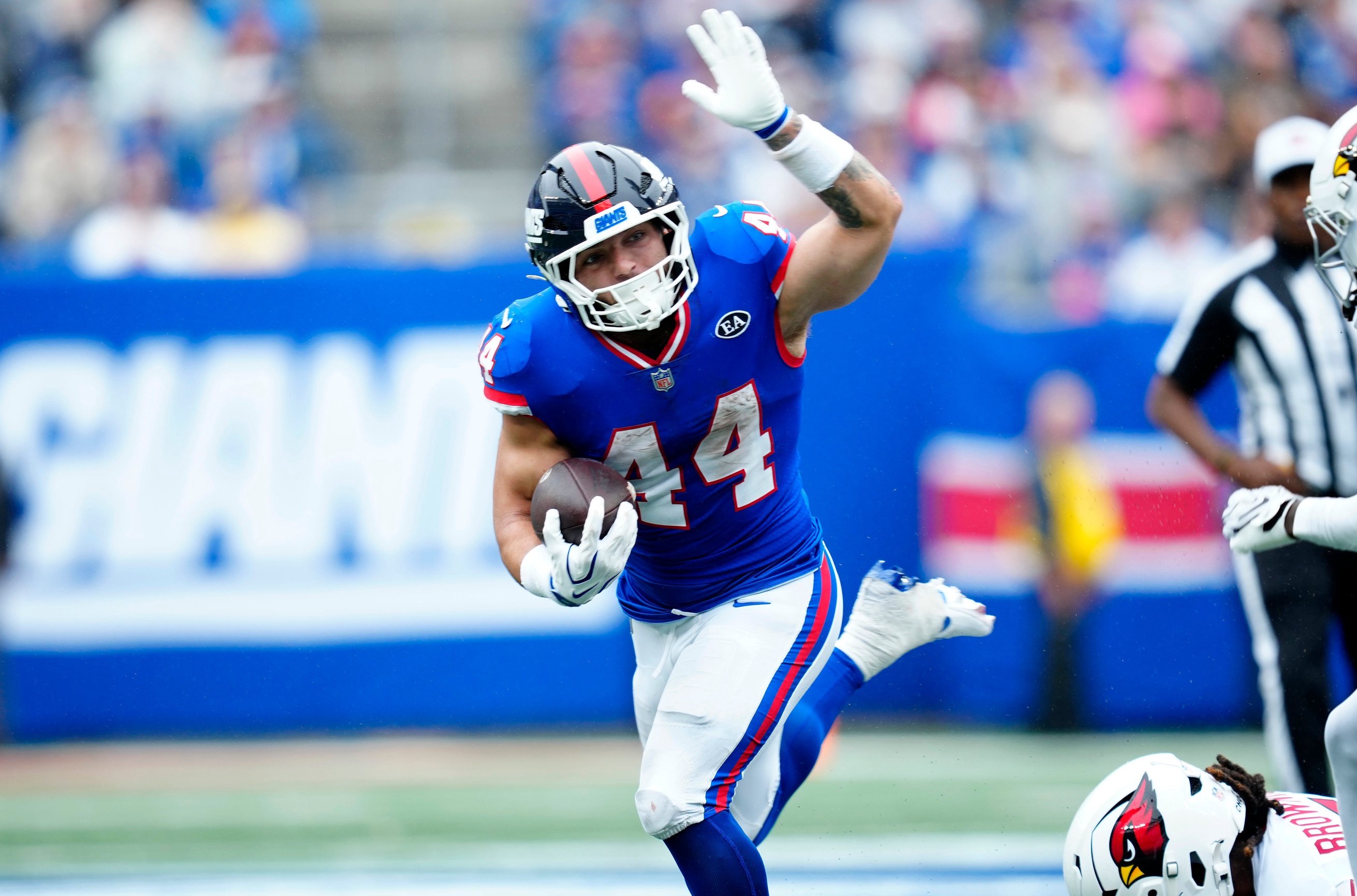 New York Giants running back Cam Skattebo (44) loses his balance but continues running with the ball, Sunday, Oct. 4, 2026, in East Rutherford.