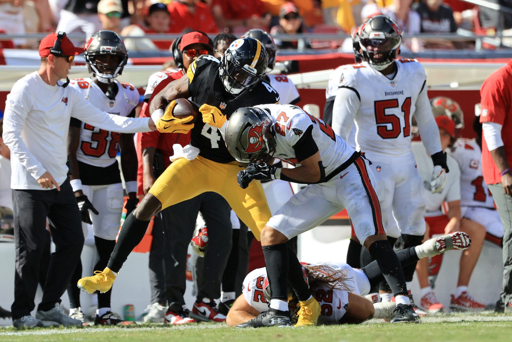 Oct 18, 2026; Tampa, Florida, USA;  Pittsburgh Steelers wide receiver DK Metcalf (4) runs after making a catch as Tampa Bay Buccaneers cornerback Zyon McCollum (27) tackles during the fourth quarter at Raymond James Stadium.  Mandatory Credit: Kim Klement Neitzel-Imagn Images