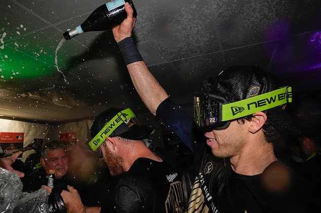 Milwaukee Brewers designated hitter Christian Yelich, right, celebrates with teammates after winning baseball's World Series, against the Tampa Bay Rays, Wednesday, Oct. 28, 2026, in St. Petersburg, Fla. (AP Photo/Chris O'Meara)