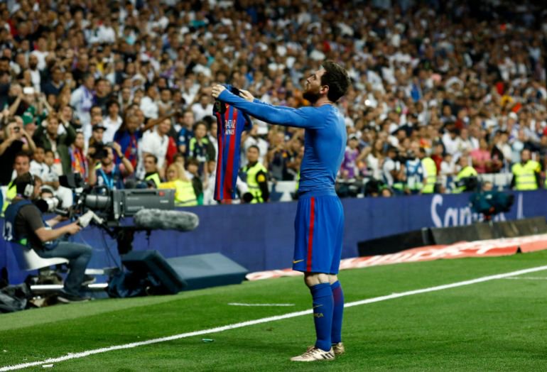 Barcelona's Argentinian forward Lionel Messi celebrates after scoring during the Spanish league Clasico football match Real Madrid CF vs FC Barcelona at the Santiago Bernabeu stadium in Madrid on April 23, 2017. (Photo by OSCAR DEL POZO / AFP)