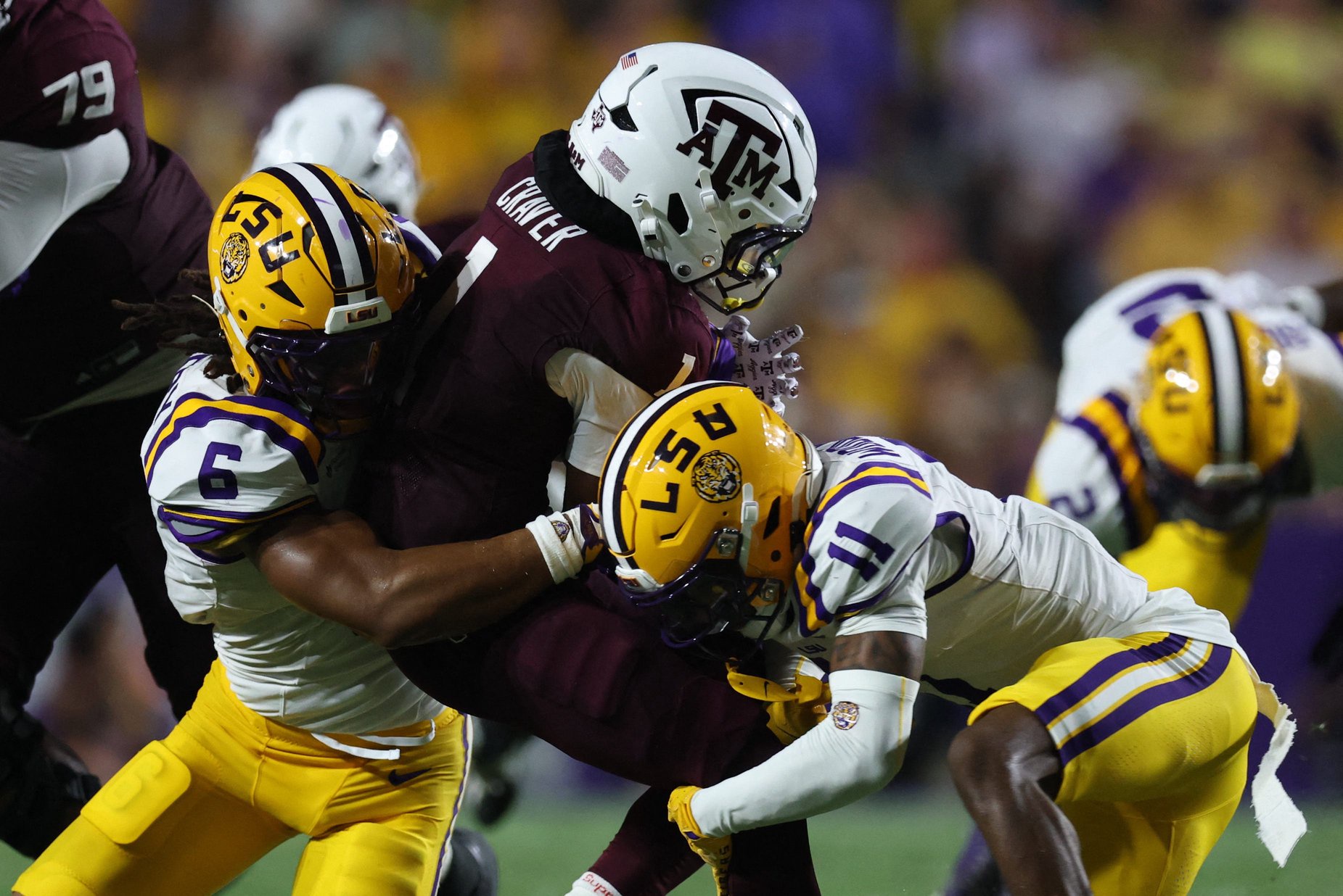 Sep 26, 2026; Baton Rouge, Louisiana, USA;  Texas A&amp;M Aggies wide receiver Mario Craver (1) is tackled by LSU Tigers linebacker TJ Dottery (6) and cornerback PJ Woodland (11) during the second quarter at Tiger Stadium.  Mandatory Credit: Stephen Lew-Imagn Images