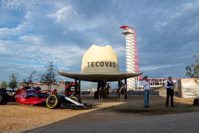 Large cowboy hat next to racecar