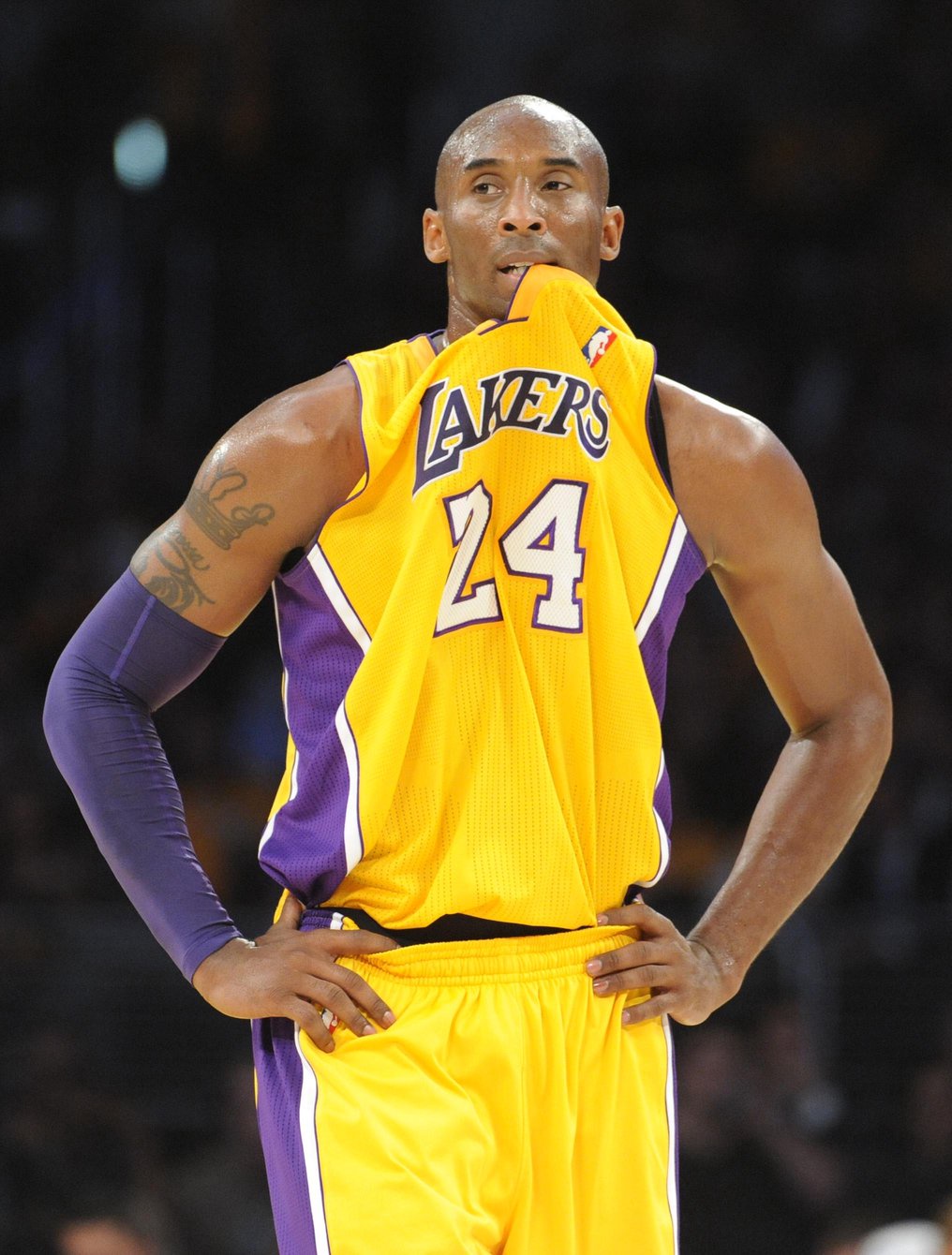 Kobe Bryant in a Los Angeles Lakers jersey with his hands on his hips.