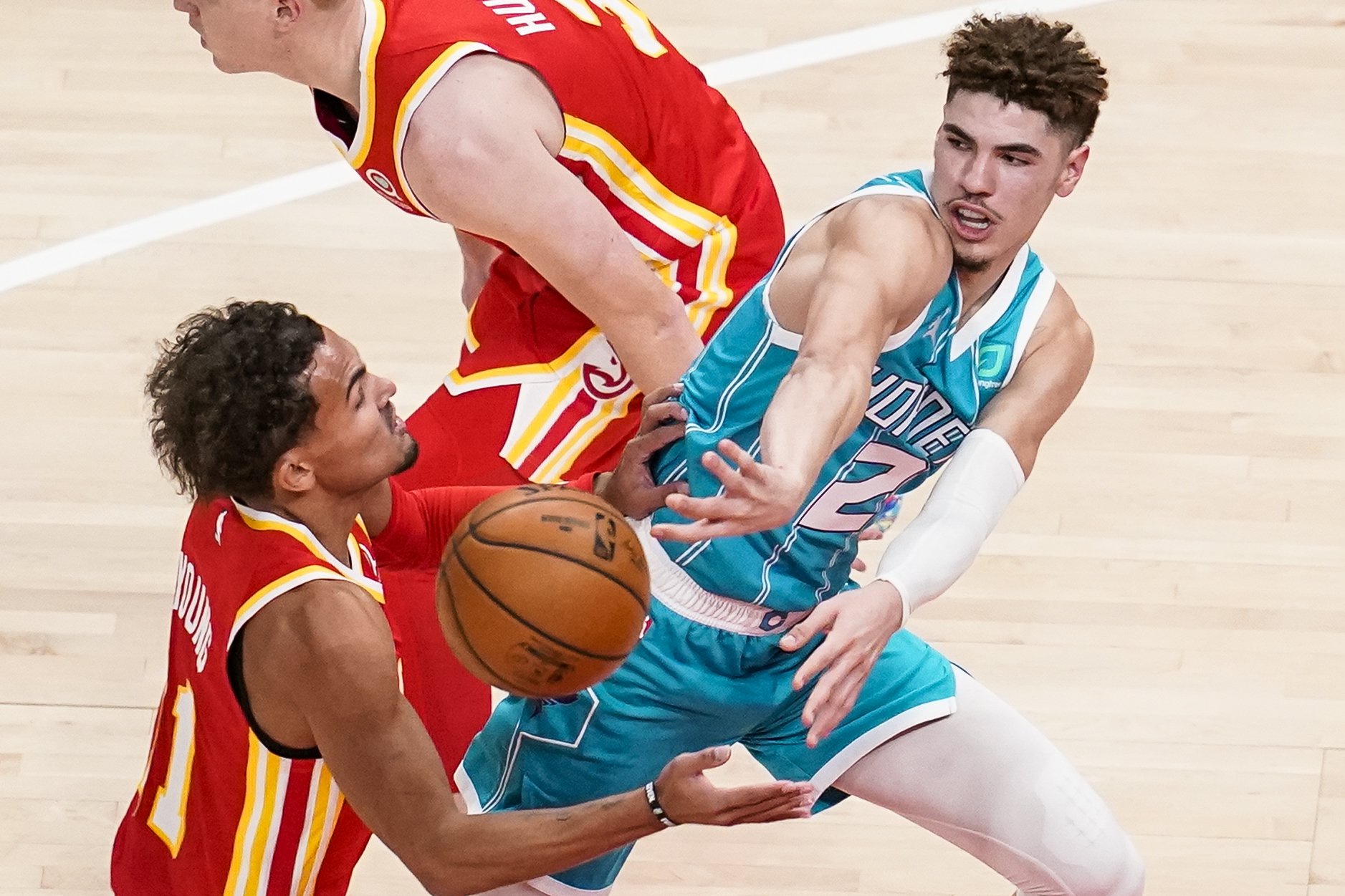 Jan 6, 2021; Atlanta, Georgia, USA; Charlotte Hornets guard LaMelo Ball (2) passes the ball around Atlanta Hawks guard Trae Young (11) during the first half at State Farm Arena. Mandatory Credit: Dale Zanine-USA TODAY Sports