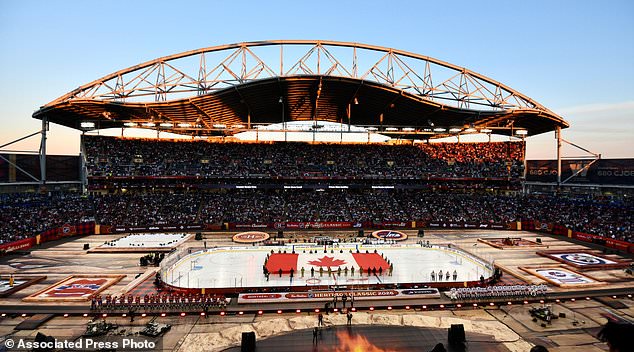 A Canadian flag is unfurled at Princess Auto Stadium before the NHL Heritage Classic hockey game between the Winnipeg Jets and the Montreal Canadiens in Winnipeg, Manitoba, Sunday, Oct. 25, 2026. (Fred Greenslade/The Canadian Press via AP)