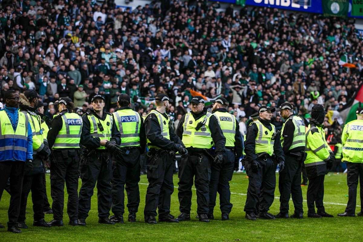 Police block fans getting onto the pitch after the Scottish Cup tie between Rangers and Celtic at Ibrox.