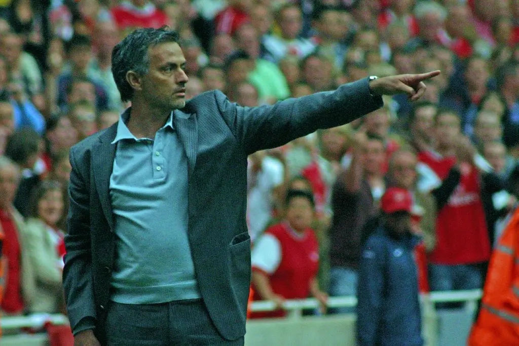José Mourinho pointing with his arm during a football match.