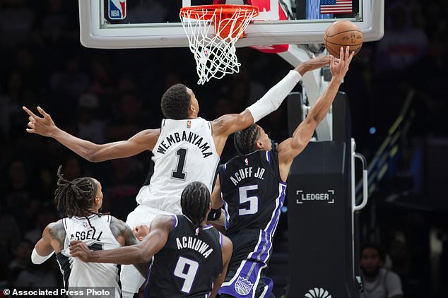 San Antonio Spurs center Victor Wembanyama (1) defends Sacramento Kings guard Darius Acuff Jr. (5) during the first half of an NBA basketball game, Tuesday, Oct. 27, 2026, in San Antonio. (AP Photo/Darren Abate)