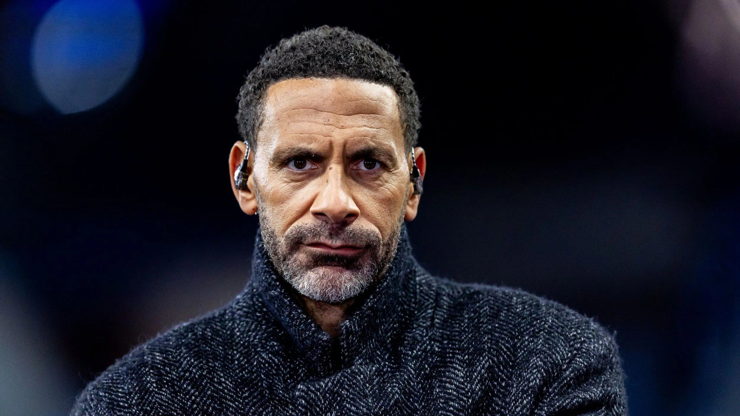 Rio Ferdinand looks on while working as a pundit