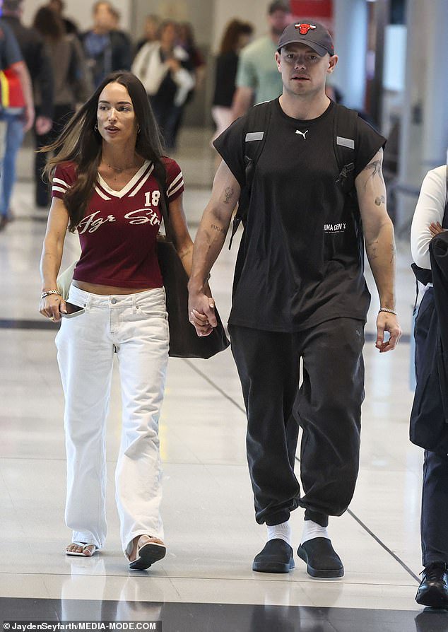 AFL star Lachie Neale held hands with his new girlfriend Emma Field as they strolled through Brisbane Airport on Wednesday