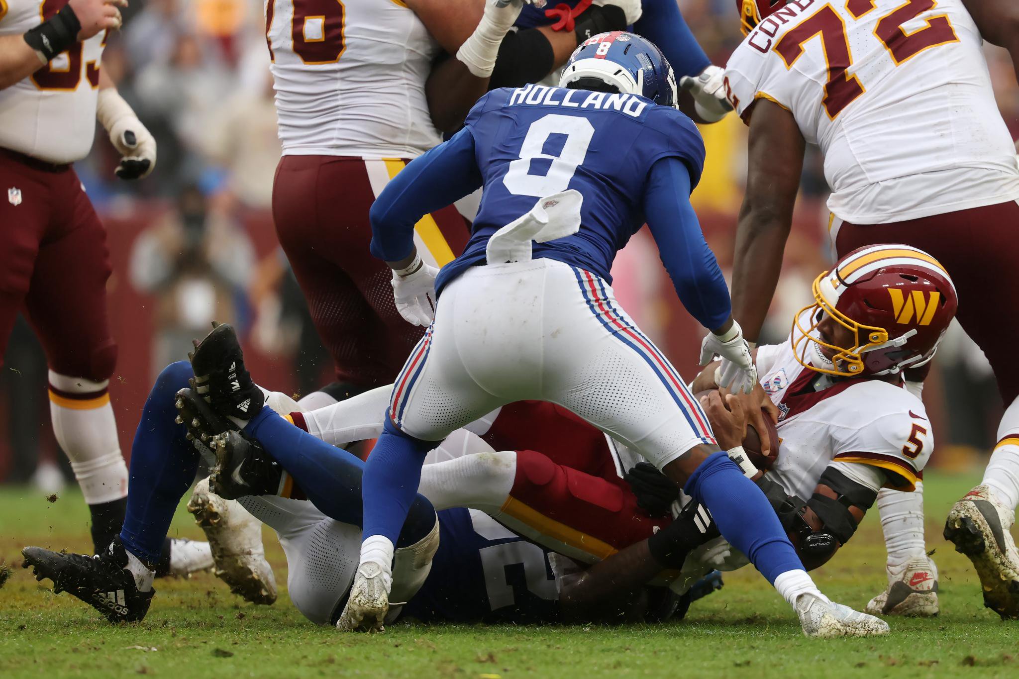 Washington Commanders' Jayden Daniels is tackled during a game against the New York Giants.