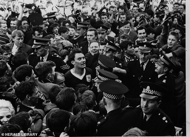 Alan Gilzean is mobbed by supporters after Dundee clinched the league title in 1962