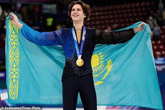 FILE - Gold medalist Mikhail Shaidorov of Kazakhstan displays his medal after competing in the men's free skate program in figure skating at the 2026 Winter Olympics, in Milan, Italy, Friday, Feb. 13, 2026. (AP Photo/Ashley Landis, File)