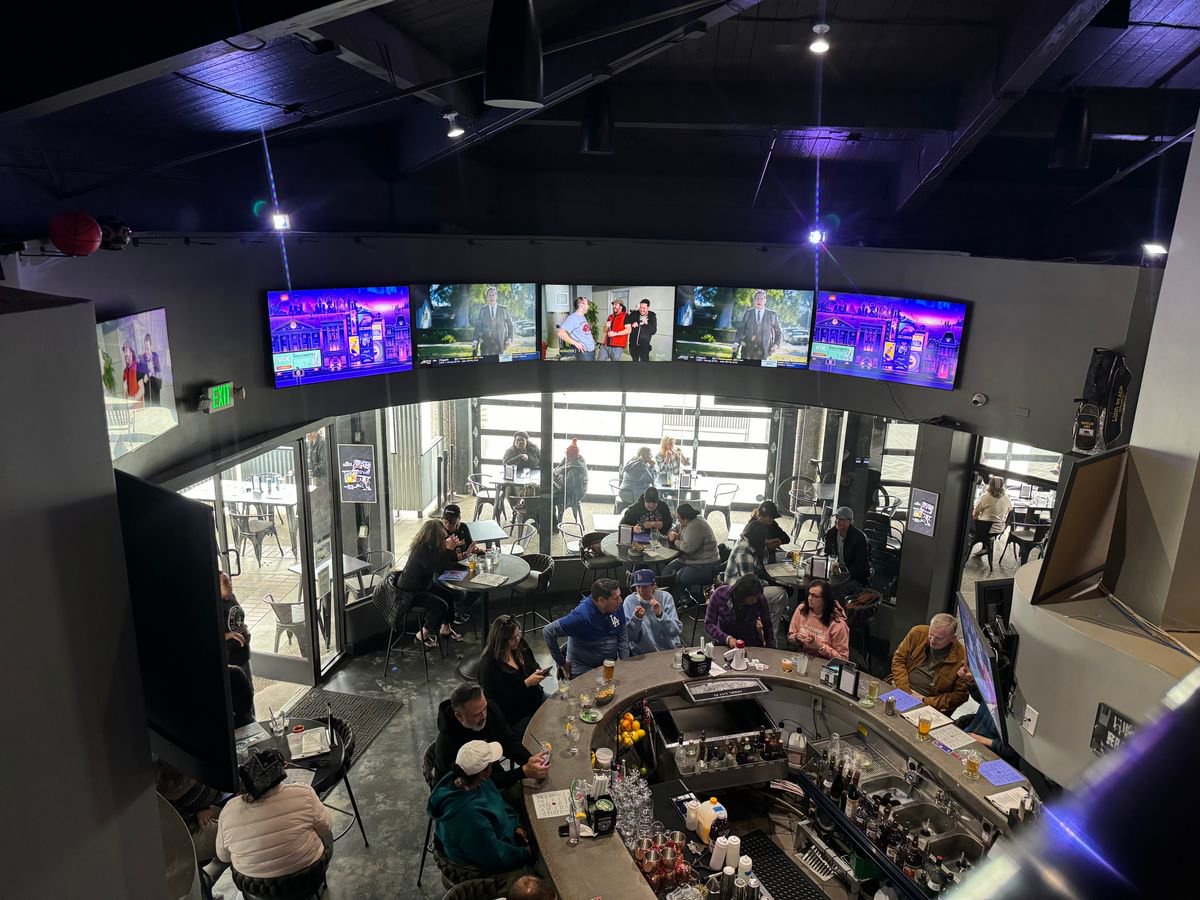 The interior of Watch Me! Sports Bar features a plethora of TV screens, each displaying a different women's sport