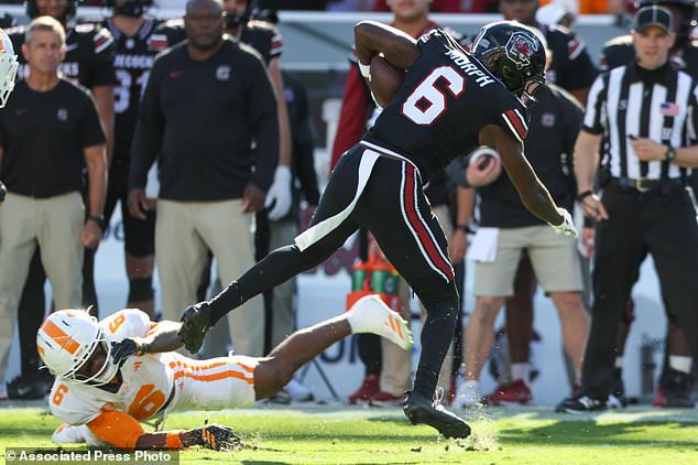 Tennessee defensive back Qua Moss, left, trips South Carolina wide receiver Donovan Murph, right, during the first half of an NCAA college football game Saturday, Oct. 24, 2026, in Columbia, S.C. (AP Photo/Artie Walker Jr.)