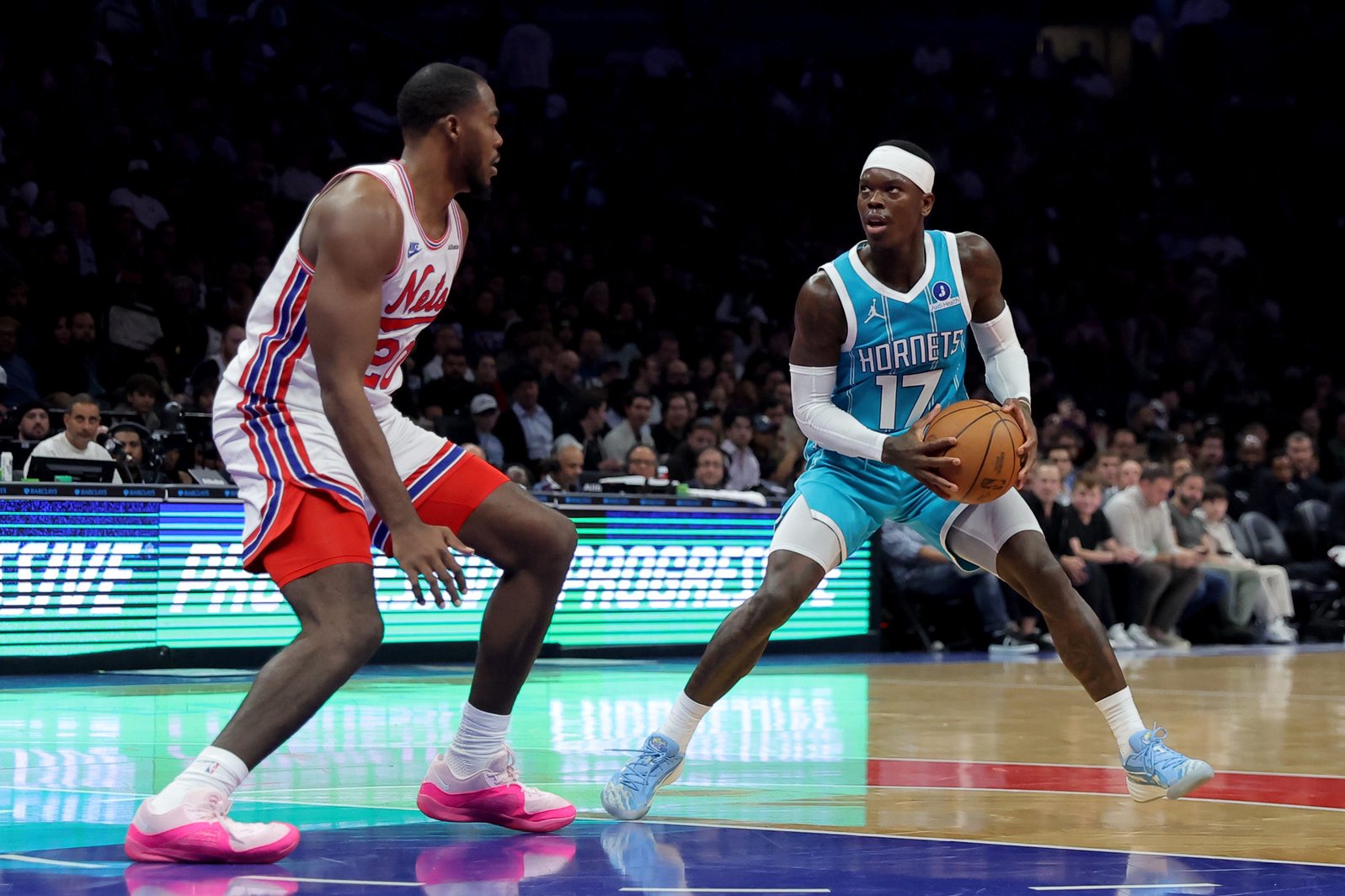 Oct 21, 2026; Brooklyn, New York, USA; Charlotte Hornets guard Dennis Schroder (17) looks to shoot the ball against Brooklyn Nets center Day'ron Sharpe (20) during the second quarter at Barclays Center. Mandatory Credit: Brad Penner-Imagn Images