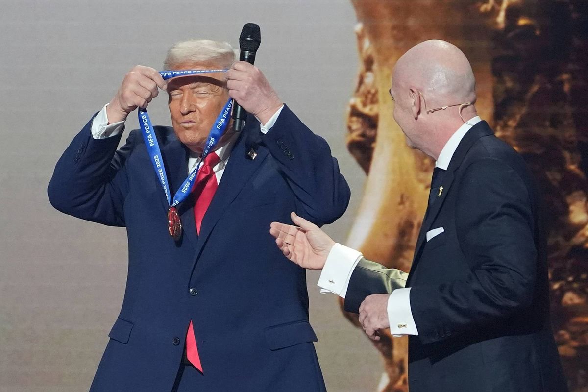 President Donald Trump puts on the inaugural FIFA Peace Prize presented to him by FIFA President Gianni Infantino during the 2026 FIFA World Cup draw at the Kennedy Center in Washington, Dec. 5, 2025.