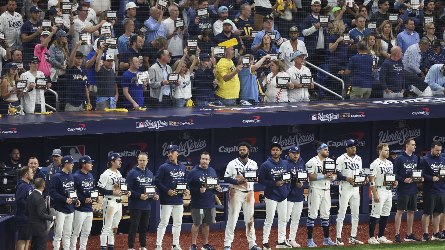 The Rays stood by the dugout holding up their Stand Up To Cancer cards during Game 4 of the World Series.