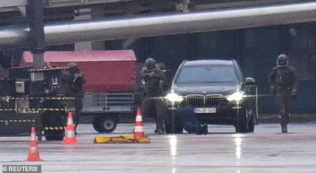 Special forces detain a suspect, after a man drove through a barrier onto the grounds of the city's airport with a child in his car in Hamburg