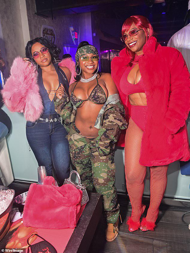 Good company: The mother-daughter duo posed for snapshots with good pal Kandi Burruss who put her curves on display in a red monochromatic get-up that featured a mockneck top and a pair of high-legged hot pants