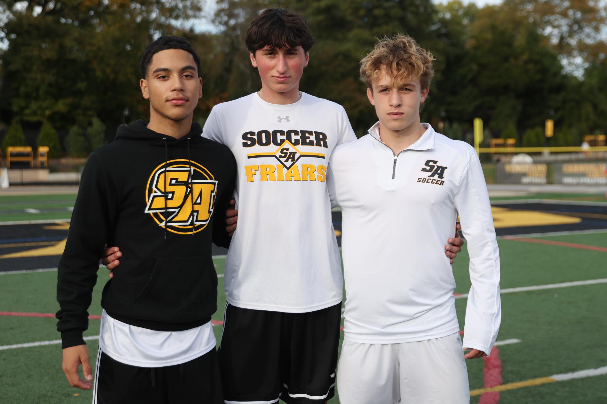 Jayden Crespi, James Kelly, and Nick Gentile pose for a portrait during soccer practice at St. Anthony's High School.