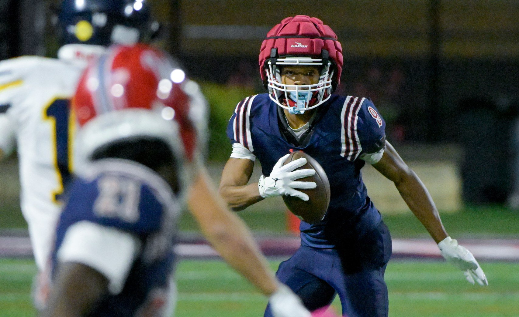 West Aurora's Travis Brown (9) looks for a hole against Leyden during a Class 8A opening-round playoff game in Aurora on Friday, Oct. 23, 2026. (Mark Black / The Beacon-News)
