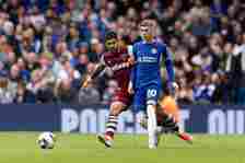 Cole Palmer of Chelsea is challenged by Emerson Palmieri of West Ham United during the Premier League match between Chelsea FC and West Ham United ...