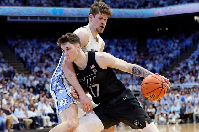 FILE - Virginia Tech guard Neoklis Avdalas (17) drives against North Carolina center Henri Veesaar, top, during the second half of an NCAA college basketball game, Feb. 28, 2026, in Chapel Hill, N.C. (AP Photo/Chris Seward, File)