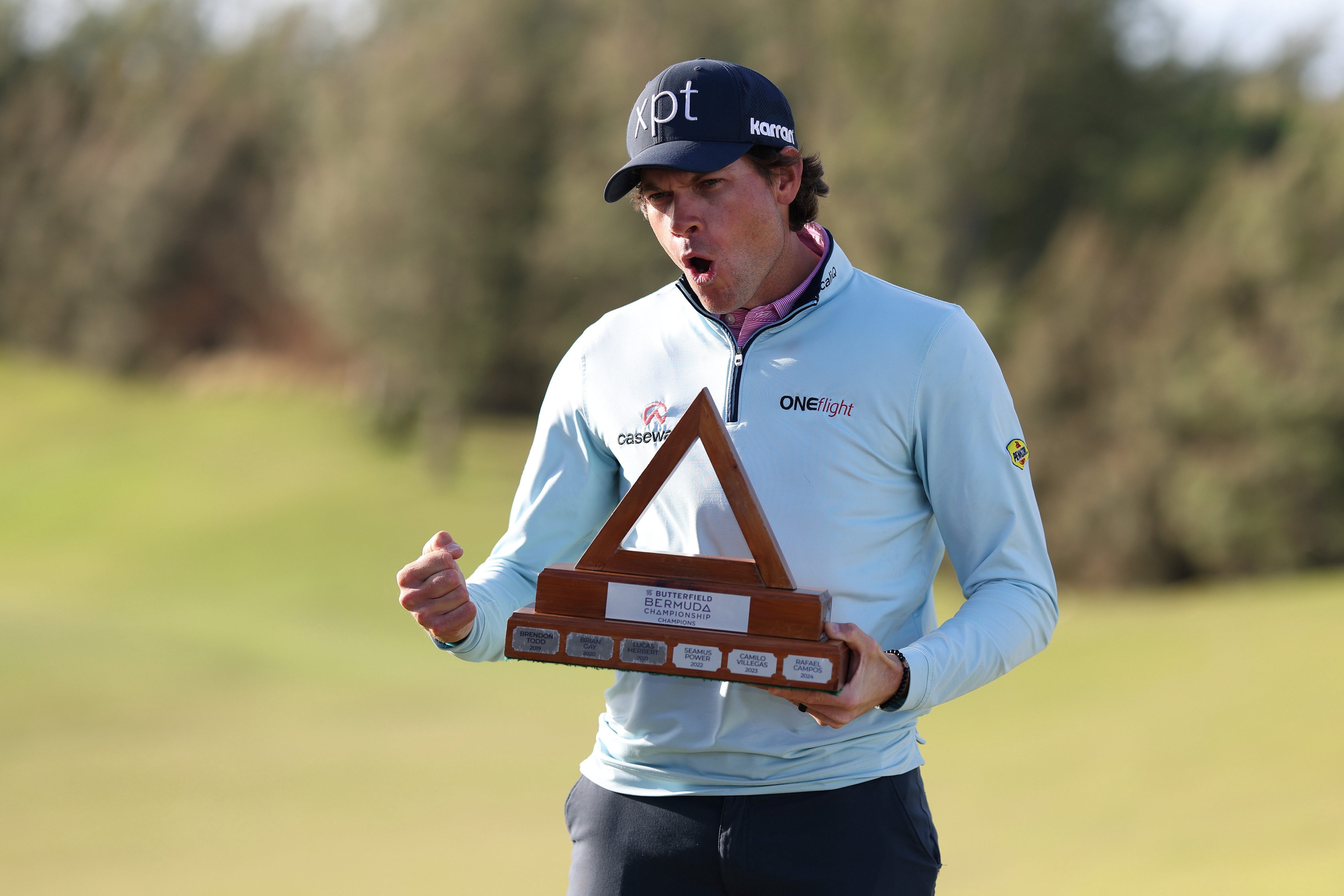 Adam Schenk celebrates with the trophy after winning the Butterfield Bermuda Championship 2025 at Port Royal Golf Course in Southampton, Bermuda. 
