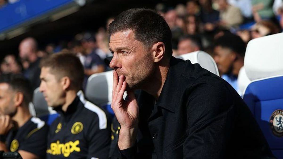 Xabi Alonso sat on the touchline with his hand to his mouth