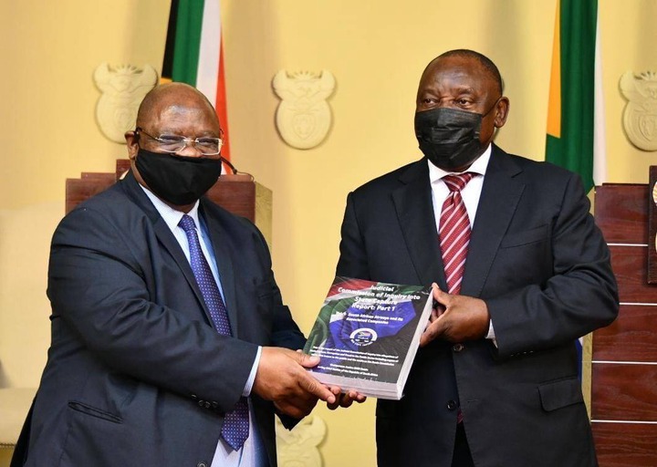 President Cyril Ramaphosa receives the report from